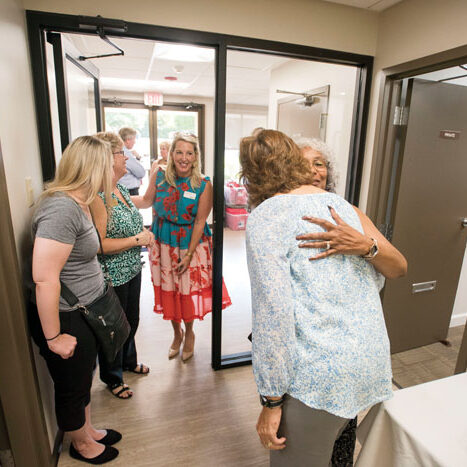 JON C. LAKEY/SALISBURY POST Clinic Excutive Director Krista Wooly (back to camera) gets a hug from P.J. Ricks before a tour. .  The Community Care Clinic on Old Mocksville Road held an open house to show off the recent remodel to supporters. With a fresh coat of paint, new floors, energy efficent lighting plus a security system are a few of the up grades to the heavily used faclity, The clinic provides primary medical and dental care as well as prescription medications to qualified under served and uninsured adults in Rowan County.  Salisbury, NC 9/9/19